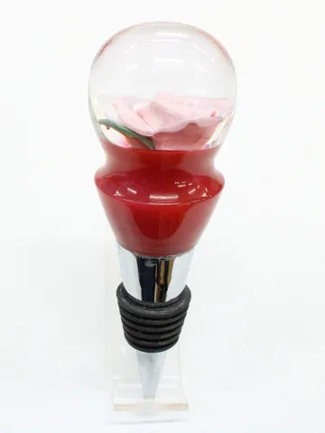 Red and pink cast bottle stopper turned by Paul on a stainless steel base