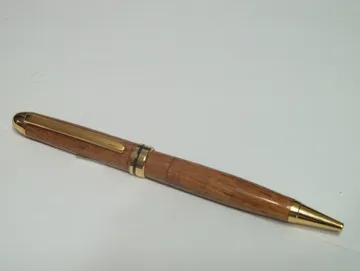 Designer twist pen turned from afzelia with 24kt gold trim